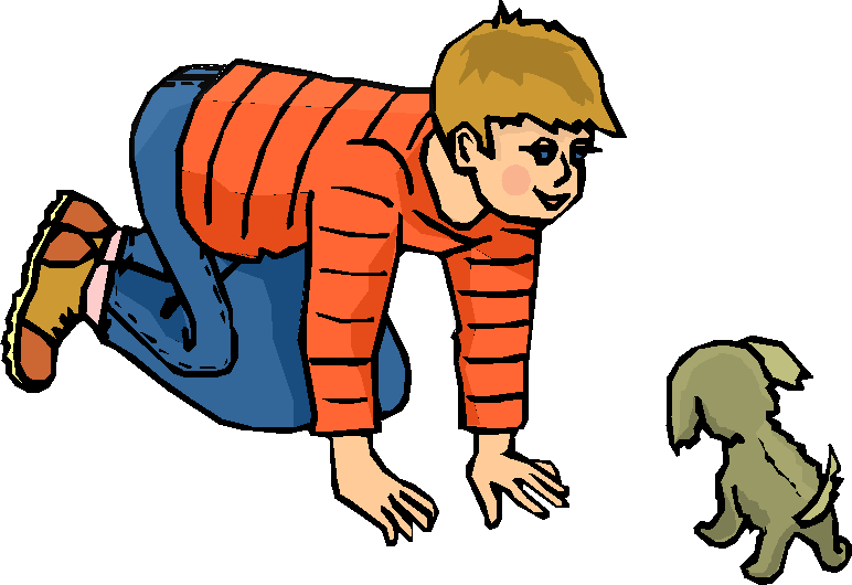 young boy playing with a puppy